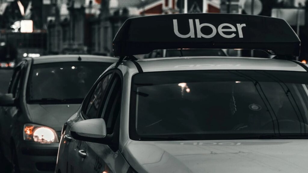 white mercedes Benz c class on street during daytime driving as Uber