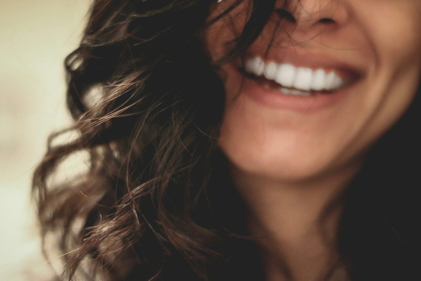 long black haired woman smiling close-up photography: Dental Health