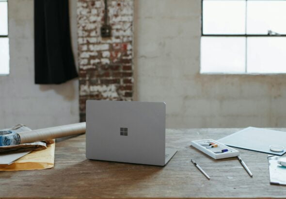 a laptop computer sitting on top of a wooden table