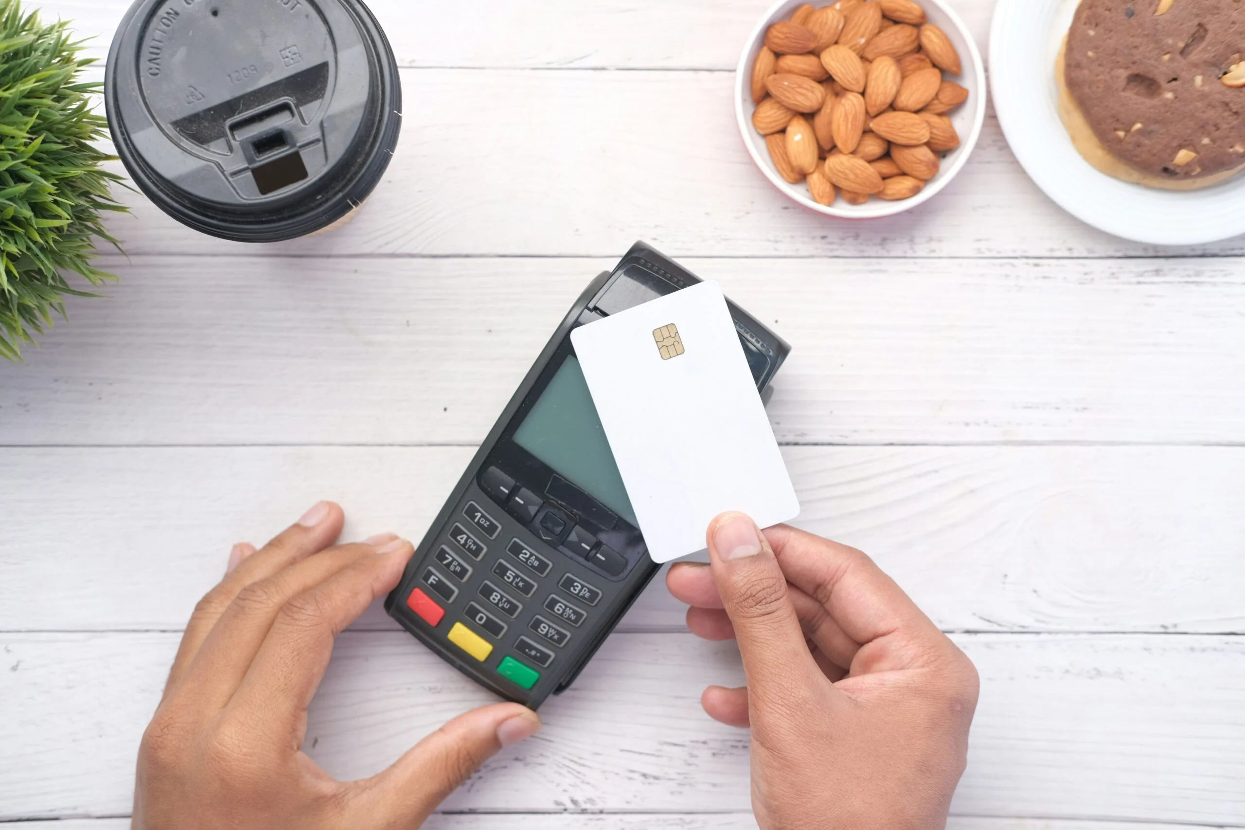 a person holding a credit card next to a calculator: Credit Scores