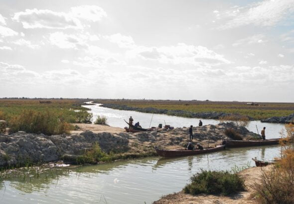 a group of people standing on top of a river