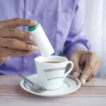 person holding white ceramic mug