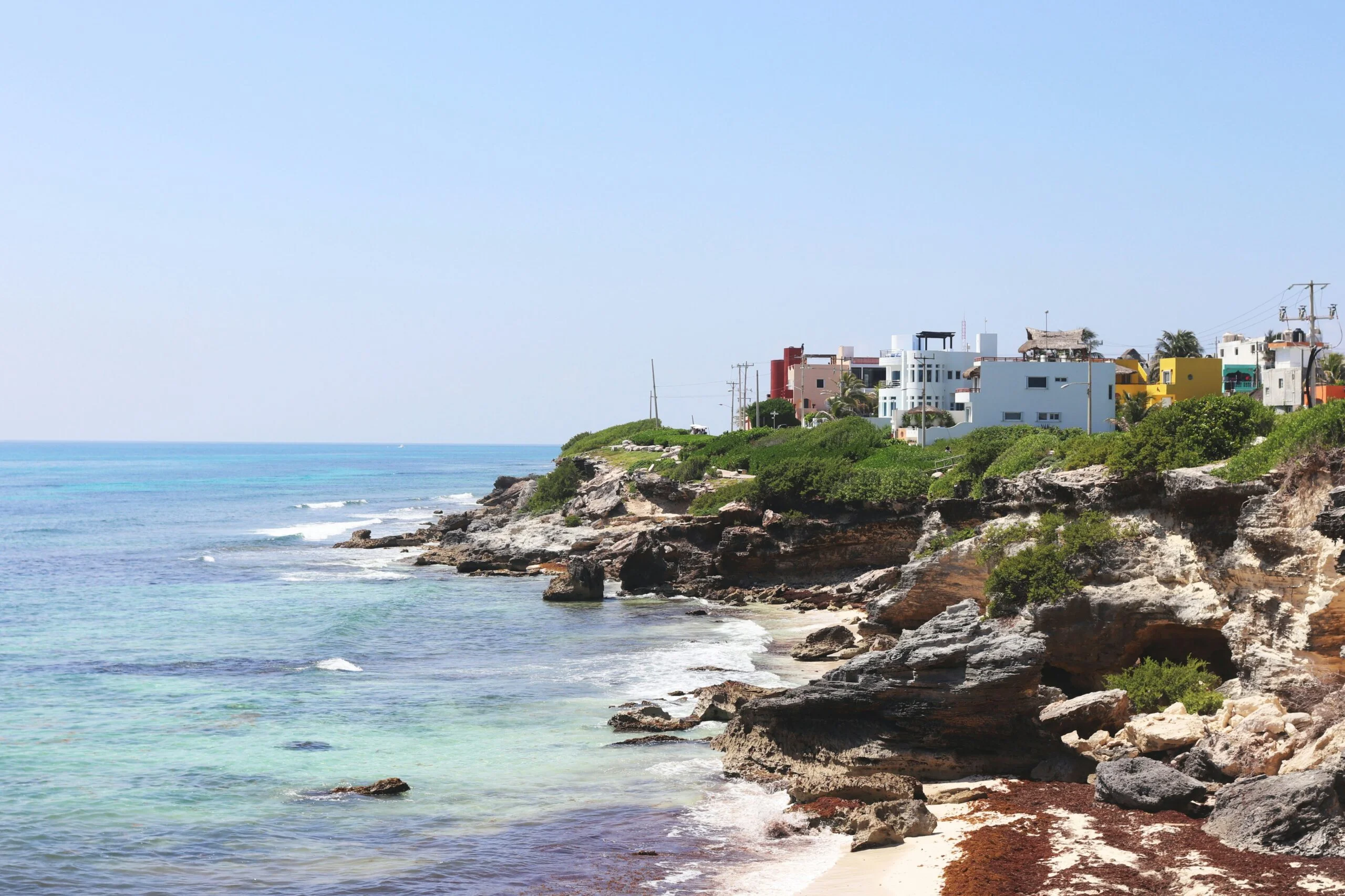 a view of a beach with houses on the cliff: Important Discoveries
