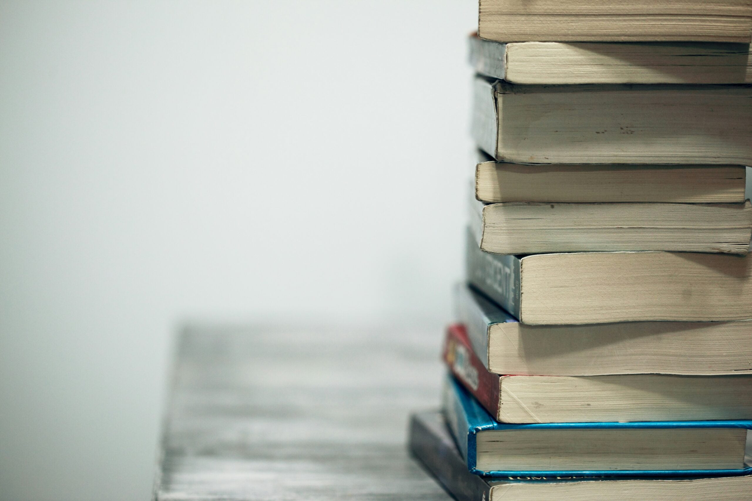 assorted books on wooden table: refers to continuing  education