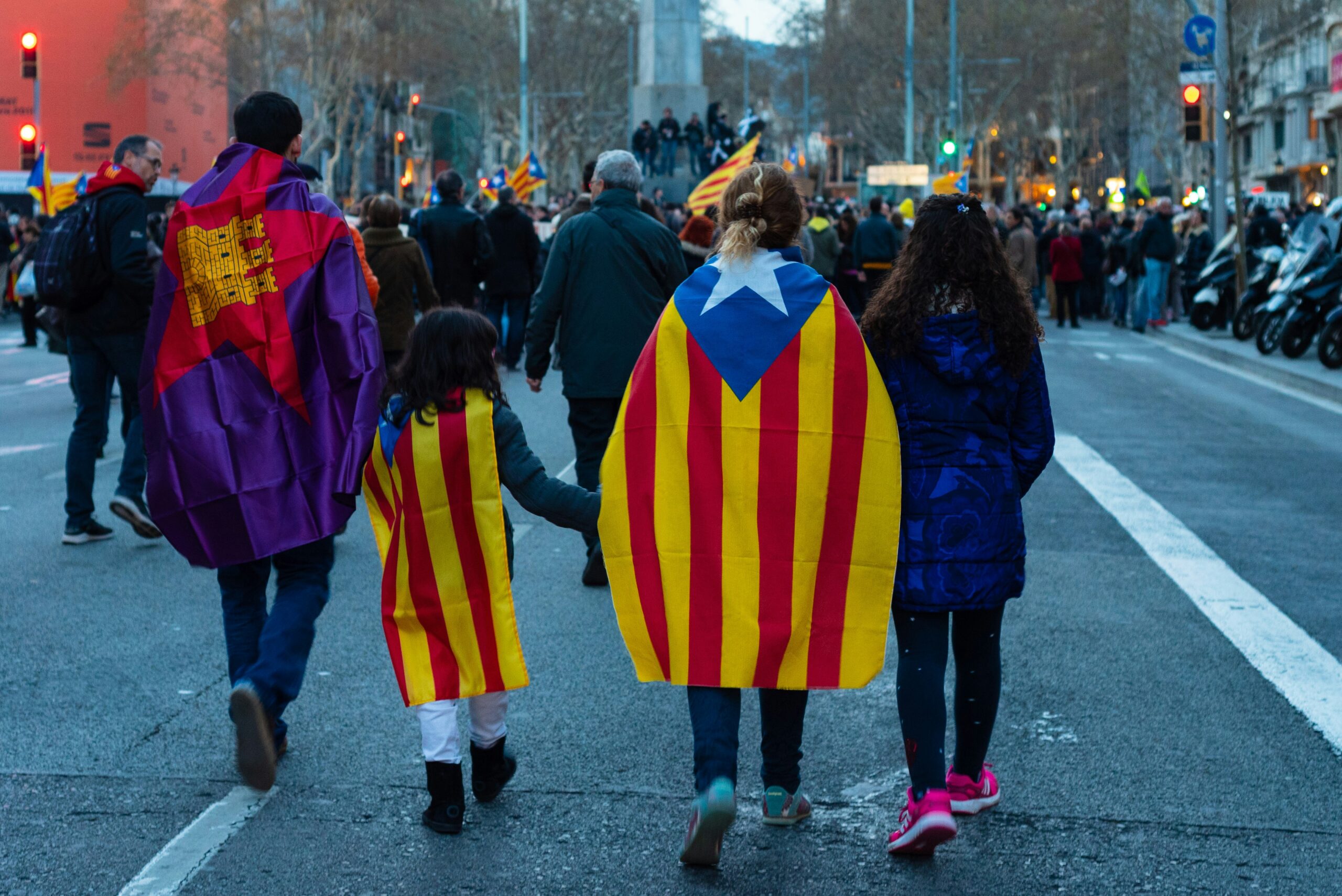 four people walking on road with flag capes: How Media Shapes Public Opinion in the Times of Crisis