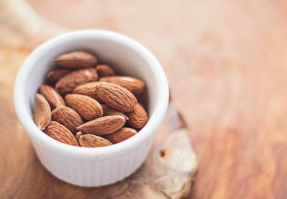 shallow focus photography of almonds in white ceramic bowl